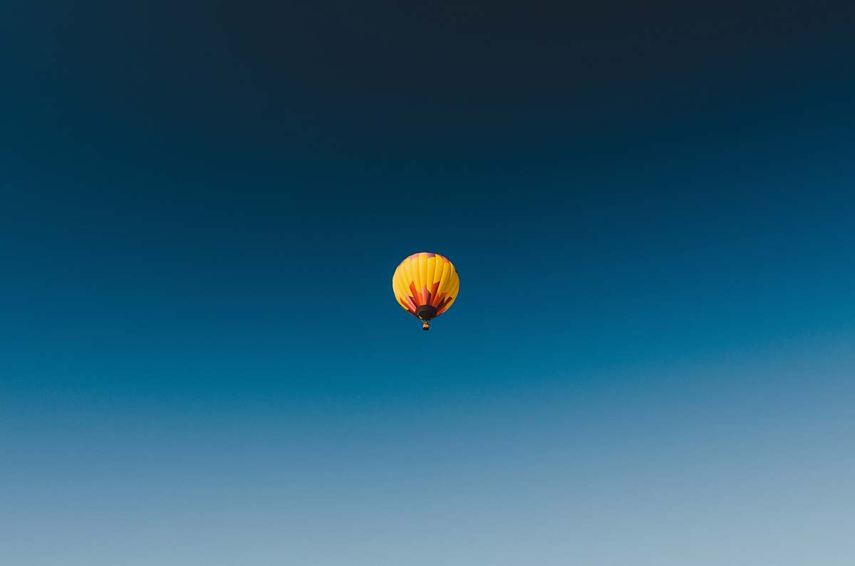 yellow worm's eye view photography of yellow hot air balloon on the skies fly